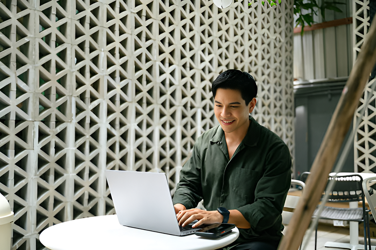 smiling entrepreneur using a laptop